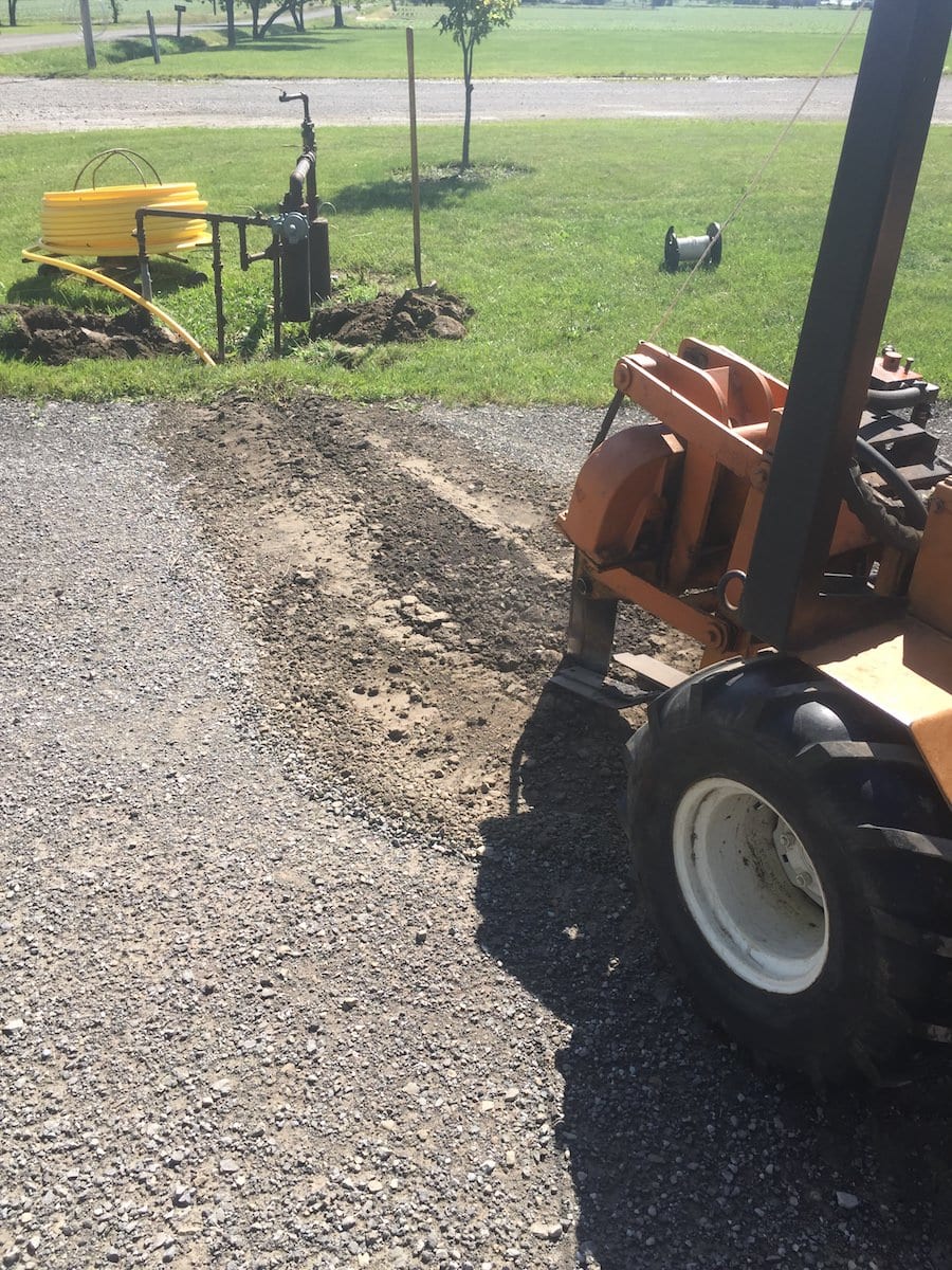 Trencher laying pipe tube